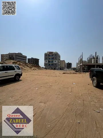 Residential-commercial land for sale in Ajman, with a permit for G+4 buildings and a prime location.
