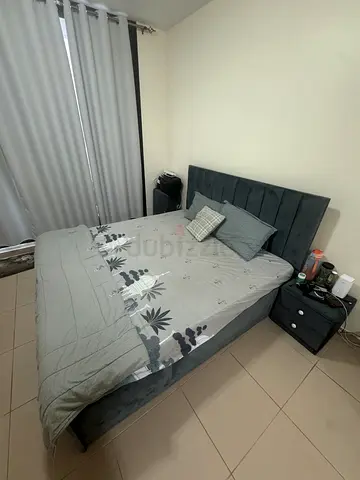Grey upholstered double bed with headboard and mattress - good condition