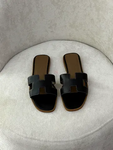 Black leather slip-on women's sandals - size not specified, gently used