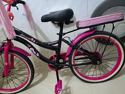 Pink and black kids' bicycle with rear rack — good condition .80 call only
