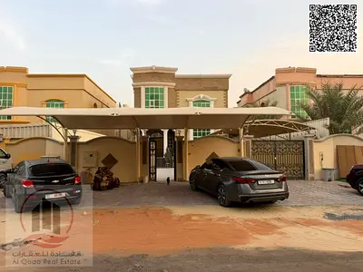 Villa for rent in Ajman, Al Muwaihat 2, 5 master bedrooms, a majlis, a living room, a maid's room, and a shaded car parking area.