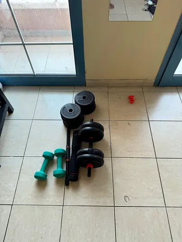 Adjustable dumbbell set with extra weight plates and pair of fixed dumbbells