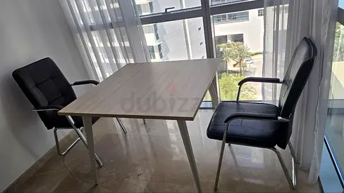 Light wood office table with 2 black chairs - good condition