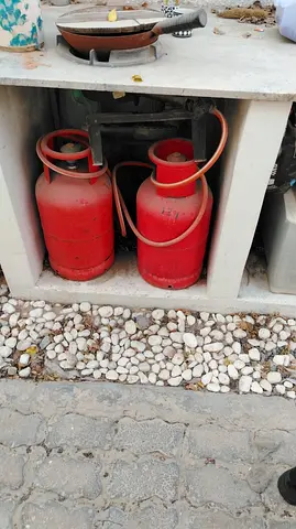 Two red LPG gas cylinders with regulator and hoses - used 200 each piece