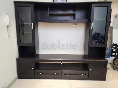 Dark wood entertainment center with glass display cabinets, good condition