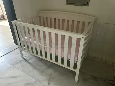 White wooden baby crib in good used condition