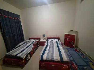 Pair of red car-shaped kids beds including mattresses with night stand and matching dresser