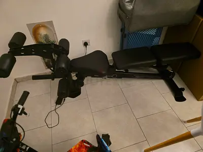 Adjustable weight bench with leg curl/extension attachment - good condition