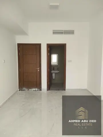 One-bedroom and living room unit for annual rent in Ajman, Al Muwaihat 3; features a master bedroom and a spacious living room. Balcony with an open v