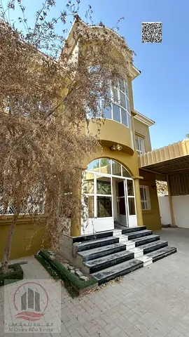 Villa for sale in Al Muwaihat, Ajman—utilities (electricity and water) included. Features 5 master bedrooms, a majlis, a living area, and a maid's roo