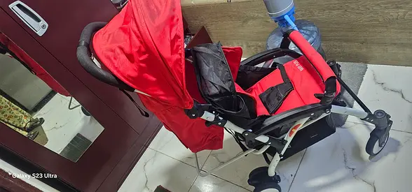 Red lightweight baby stroller / pram in good condition