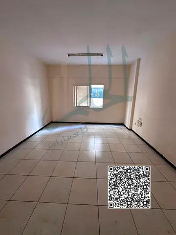 Studio for annual rent with a separate kitchen and built-in cabinets.