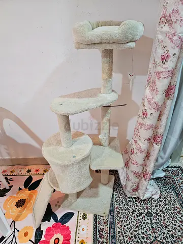 Used beige multi-level cat tree with condo and scratching posts