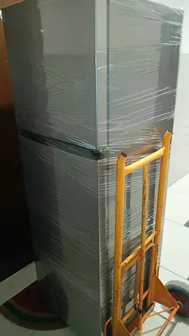 Used double-door refrigerator wrapped and ready for pickup