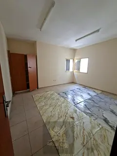 Spacious 2-bedroom apartment with a living room in Al Qasimia (Al Nad); one month free. Features 2 b