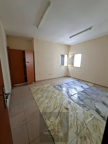 Spacious 2-bedroom apartment with a living room in Al Qasimia (Al Nad); one month free. Features 2 bathrooms, a balcony, and built-in wardrobes.