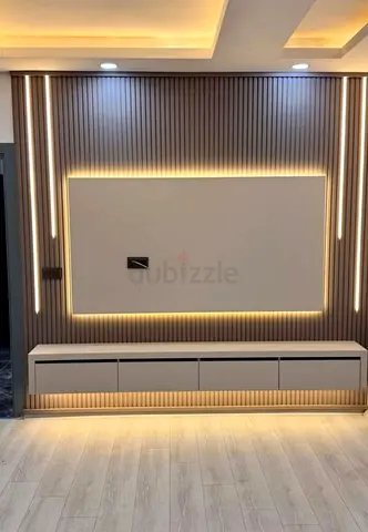 Modern wall-mounted entertainment unit with LED backlit panel and storage