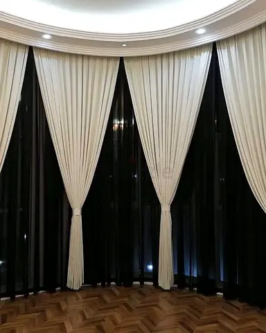 Full-length cream fabric curtains with black sheer backing, set of panels