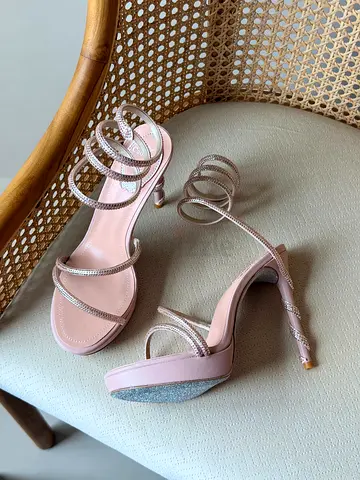 Pink strappy high-heel sandals with rhinestone straps, size unknown