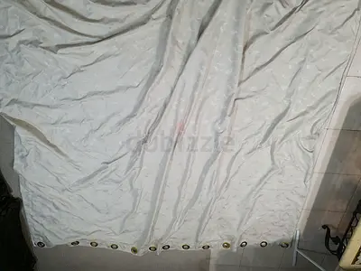 Light beige eyelet curtains with subtle pattern — set of panels
