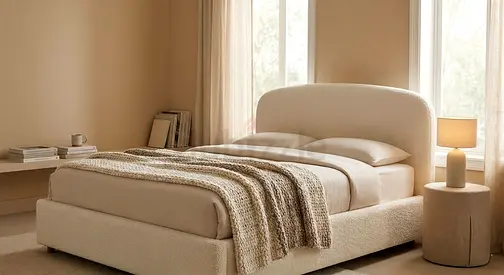 Beige upholstered double bed with curved headboard - modern cozy design