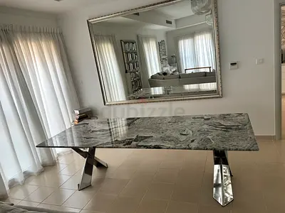 Modern marble-top dining table with stainless steel legs