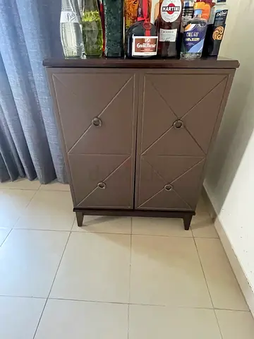 Small brown two-door storage cabinet for wine and drink storage