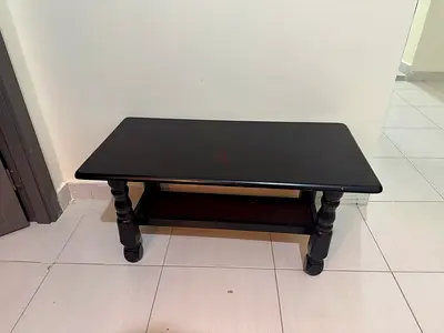 Solid dark wood coffee table with lower shelf - good condition