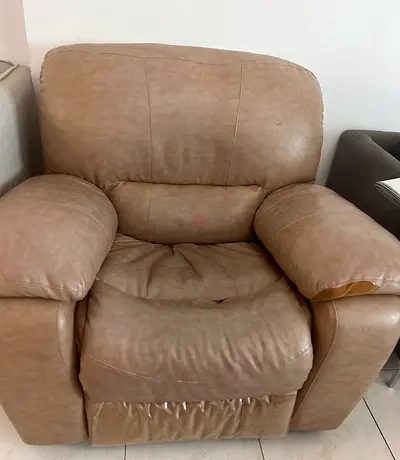 Beige leather reclining armchair - bit wear and tear but in good working condition