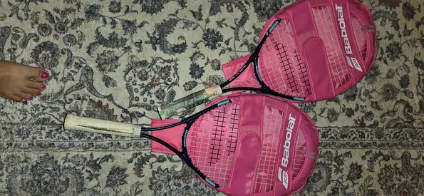 Pair of Babolat pink junior tennis rackets with covers used once