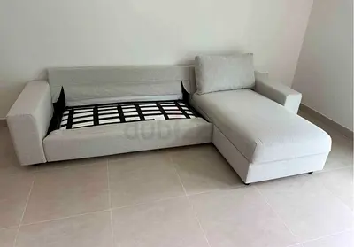 Light beige L-shaped fabric sofa bed with chaise - good condition