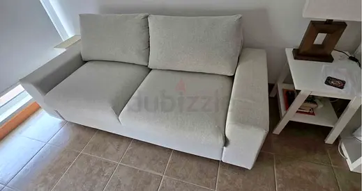 Light beige 2-seater fabric sofa bed in good condition