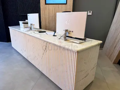 Long marble reception counter with fluted front - used