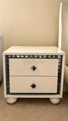 White bedside nightstand with mirrored trim and two drawers