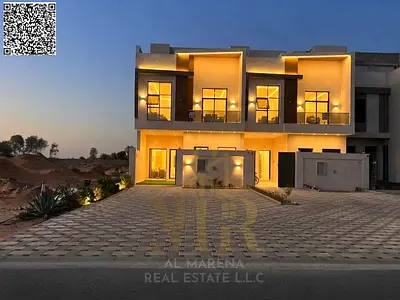 Luxury villa for sale in Al Helio, Ajman, featuring a modern design, high-end finishes, and a prime location near major roads.