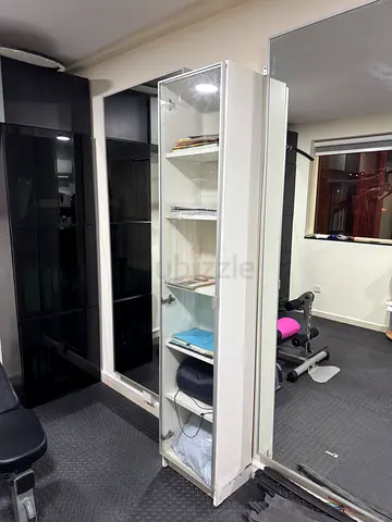 Two Ikea tall White glass display cabinet with shelves