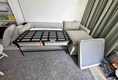 Light beige L-shaped sectional sofa bed with pull-out bed (good condition)
