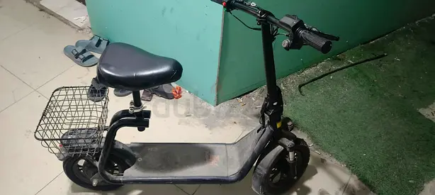 Used Electric Scooter with Seat and Front Basket - Needs Minor Repair