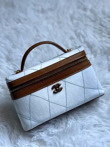 White quilted Chanel-style vanity bag with tan trim — small handbag