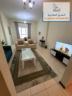 A furnished one-bedroom apartment with a living room and two bathrooms. It features hotel-style furn