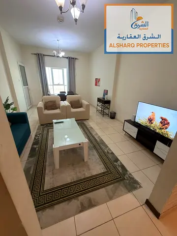 A furnished one-bedroom apartment with a living room and two bathrooms. It features hotel-style fur
