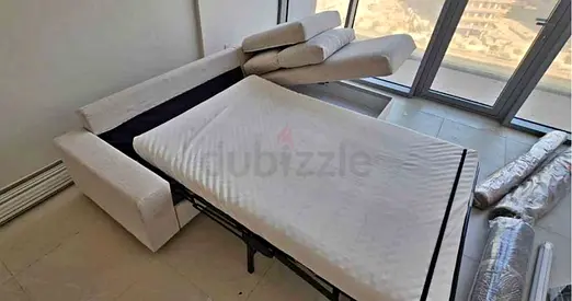 Light beige fabric sofa bed with pull-out mattress vimle