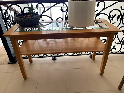 Wooden console table with glass top and lower shelf - light finish