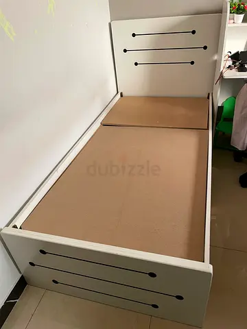 Single white wooden bed frame with headboard and footboard