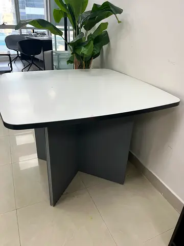 Modern white office desk with grey storage panel