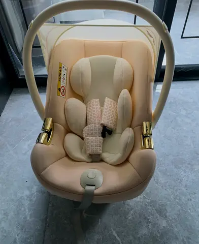 99% new - Light beige infant car seat (rear-facing) with newborn insert