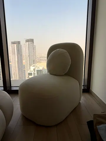 Cream upholstered lounge chair - modern curved design