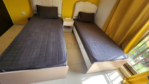 Two single white wooden beds with mattresses and nightstand - good condition