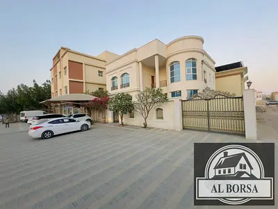 For rent in Rawda 1, a furnished villa with 5 master bedrooms, a majlis, two living rooms, a spacious kitchen, and a maid's room.