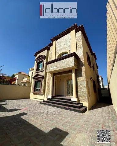 Luxury 6-master-bedroom villa for sale in Al Rawdah 1 – stone facade.